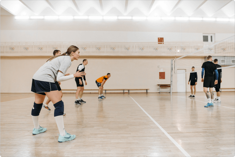 men and women playing volleyball