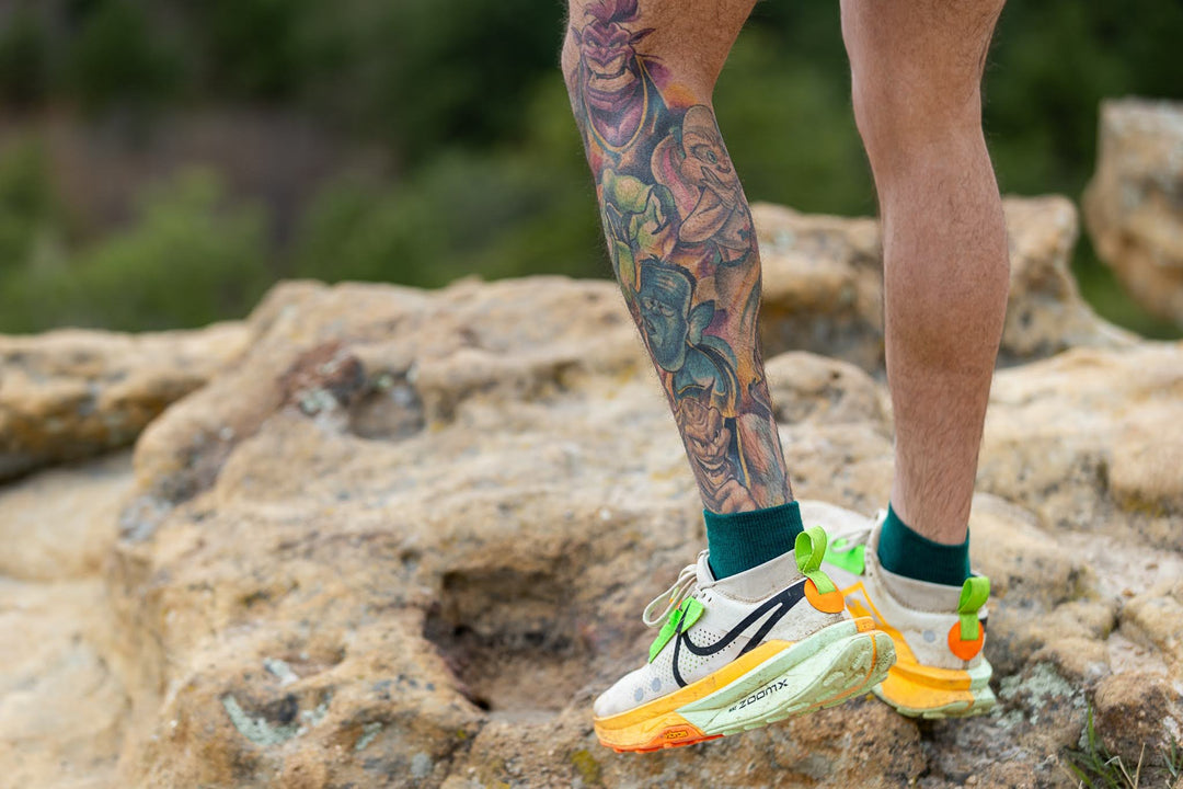 man's shoes on a rock